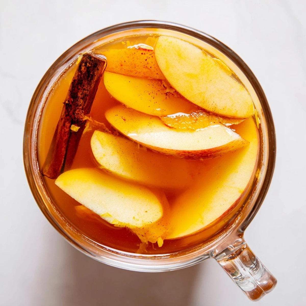 A vibrant close-up captures bubbling Spiced Apple Cider, perfect for a crisp Autumn afternoon.