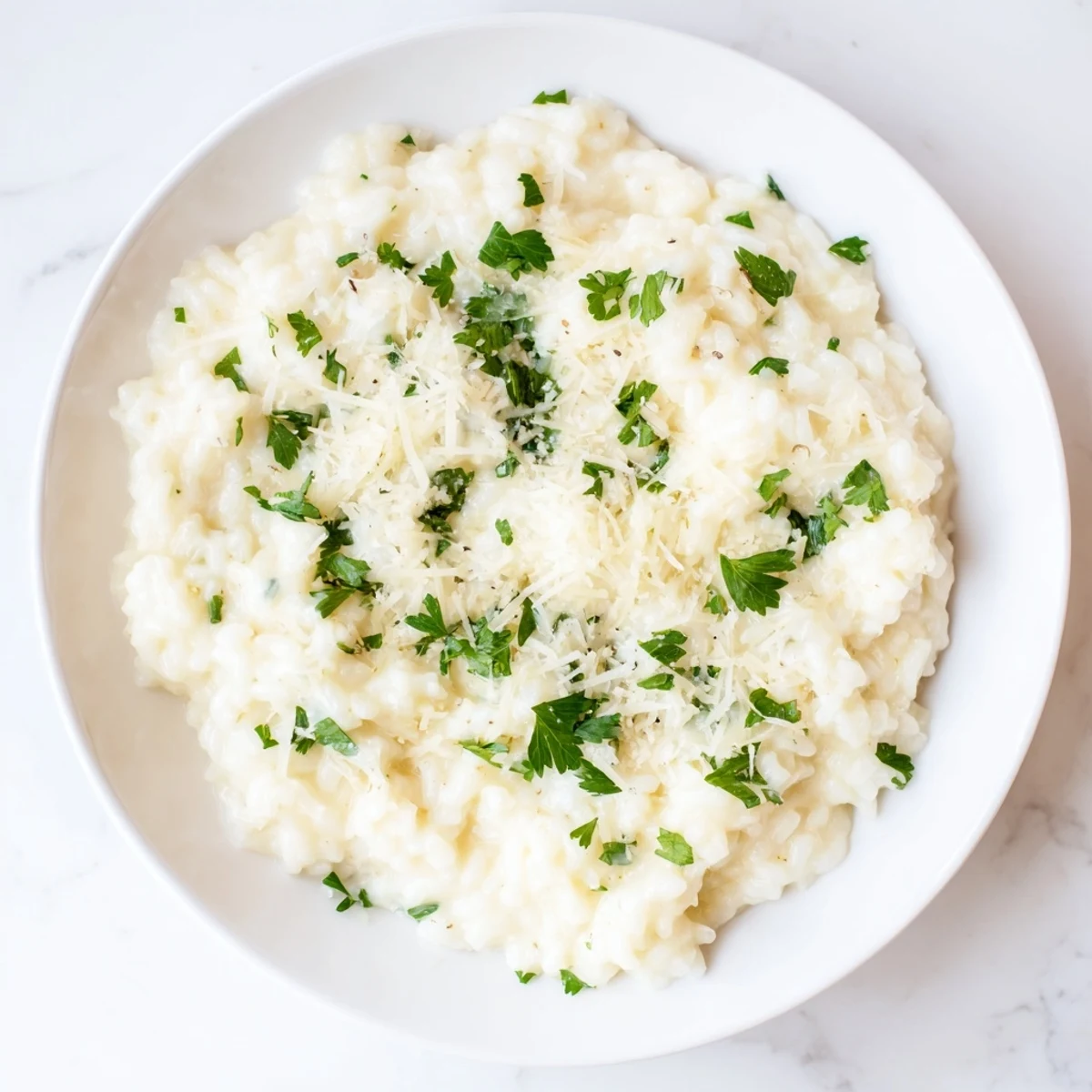 A steaming bowl of creamy rice, rich and comforting, ready for serving this vegetarian dish.