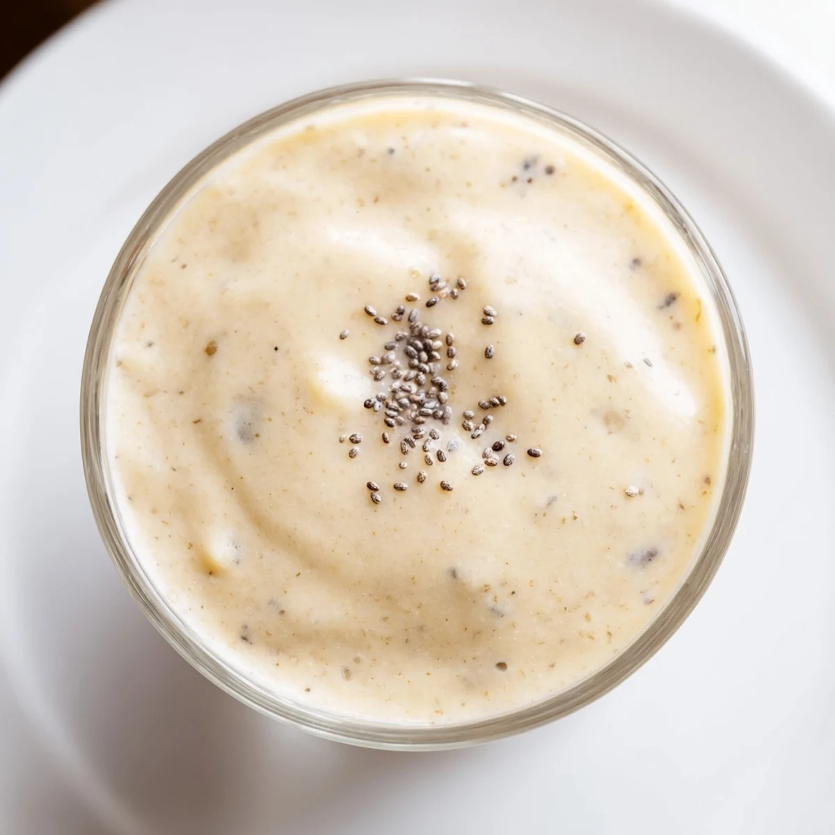 Enjoy a cold glass of homemade banana smoothie, sweet, smooth, and served immediately after blending.