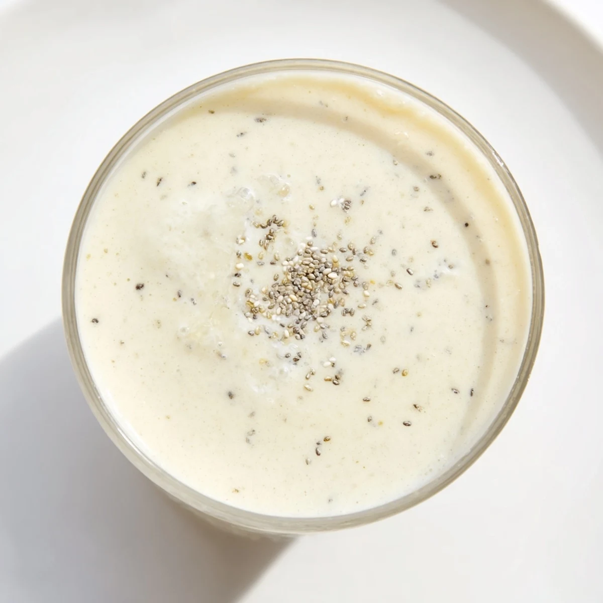 This vibrant banana smoothie shows a healthy treat, ready to drink, with a simple, refreshing taste.