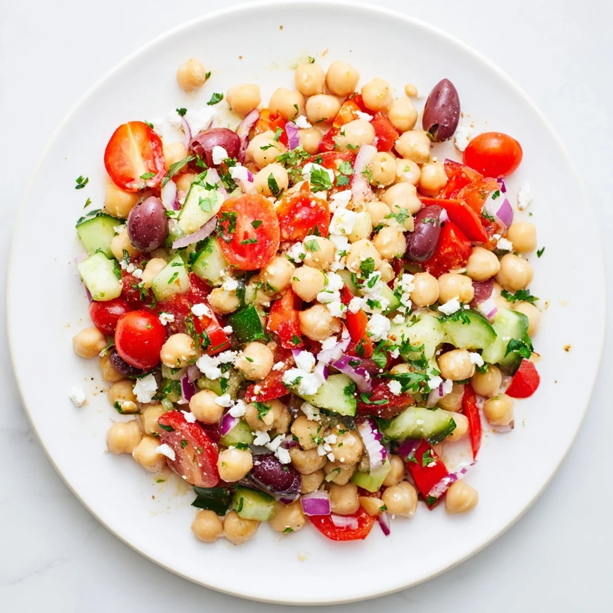 A bowl overflowing with delicious Mediterranean Chickpea Salad featuring feta, perfect for a light vegetarian meal.