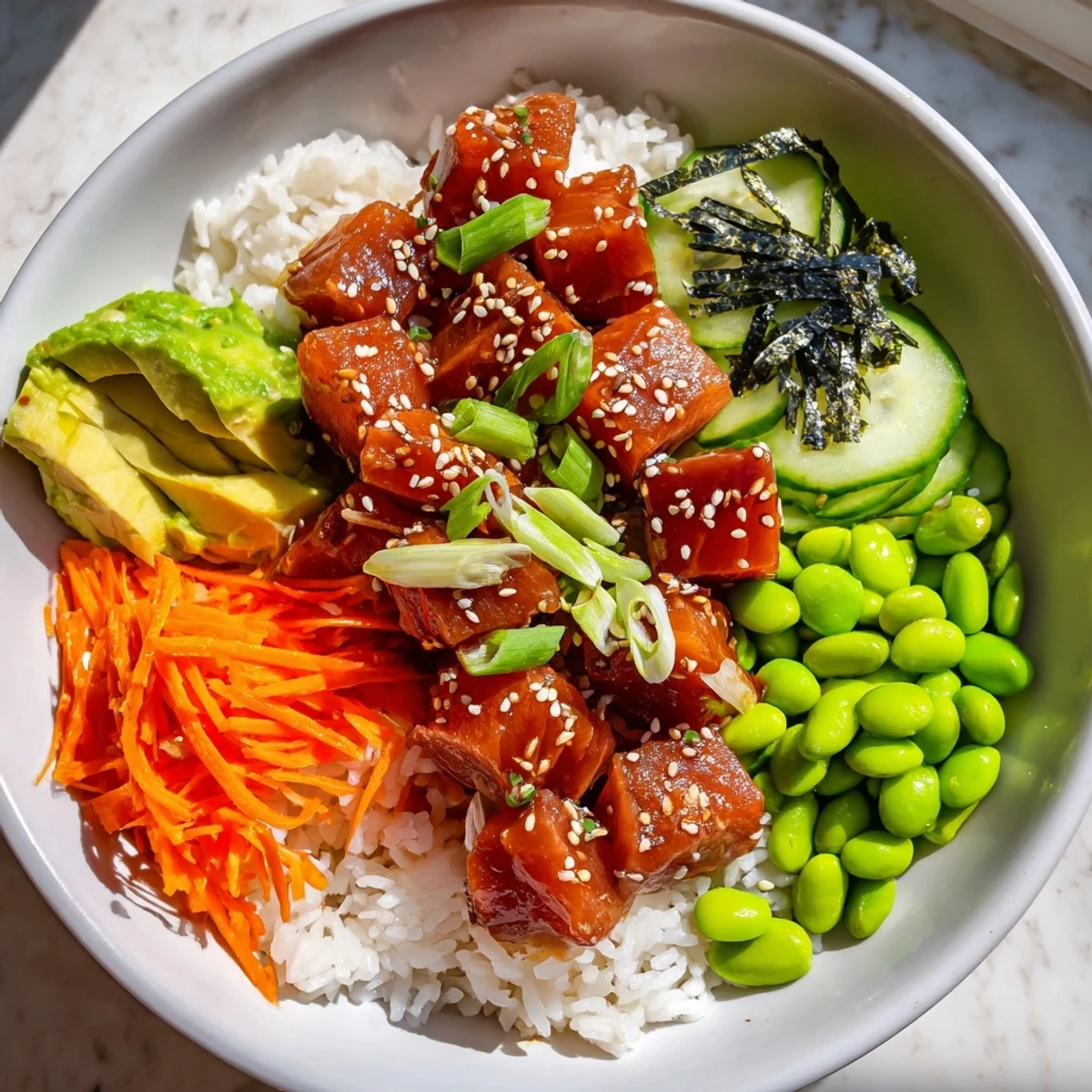 A colorful Spicy Tuna Poke Bowl, with marinated tuna and creamy avocado arranged artfully.