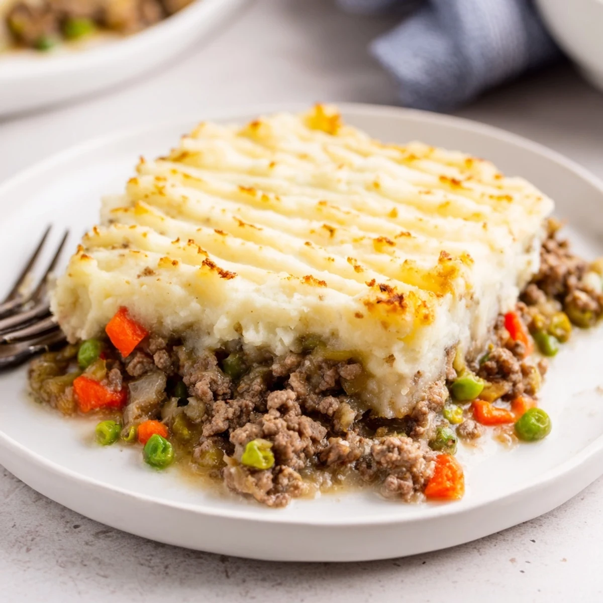 A bubbly, savory Beef Shepherd's Pie overflowing with ground beef and garden vegetables.