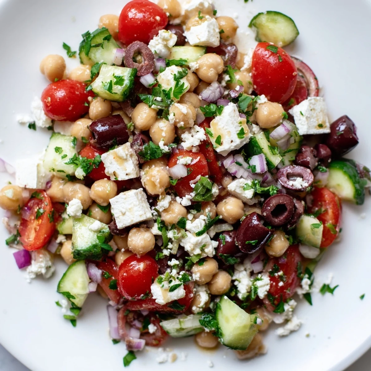 Colorful Mediterranean Chickpea salad tossed in zesty lemon-oregano dressing, served as a vibrant vegetarian side dish for lunch.