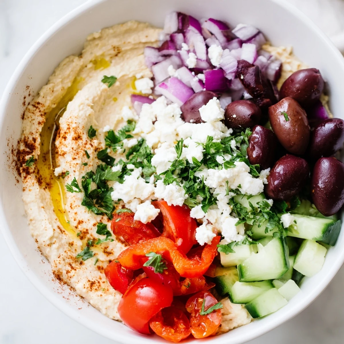 Healthy Mediterranean Hummus Bowl with soft pita, smoky paprika, and lemon wedges, perfect for a light vegetarian lunch or dinner.