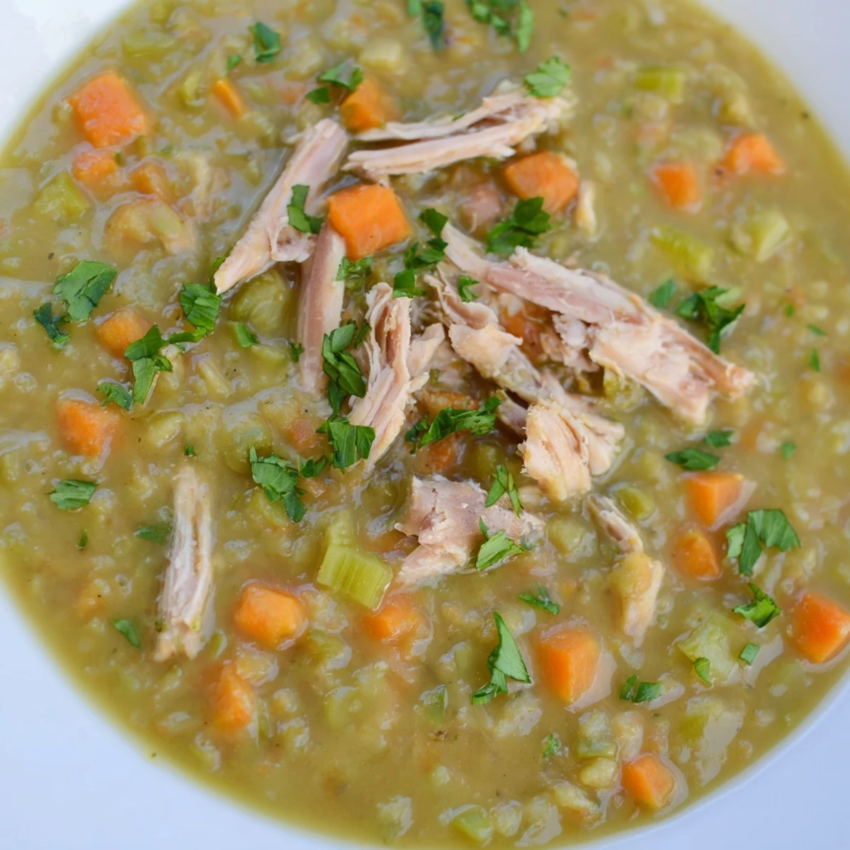 Thick, hearty Green Split Pea Soup with Smoked Turkey features tender peas and shredded meat.