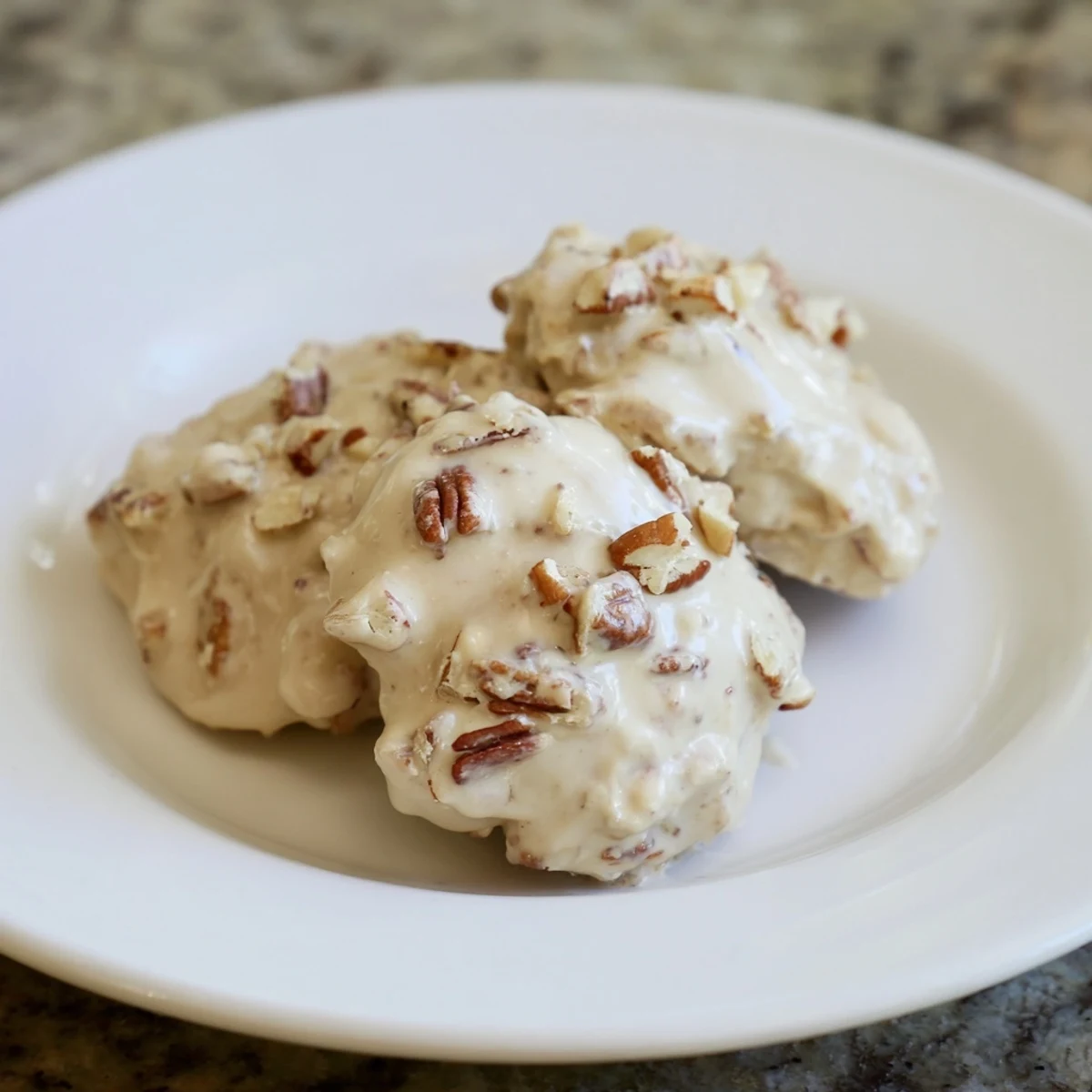 Golden Mardi Gras Pecan Pralines with Cream arranged on a parchment-lined baking sheet, showcasing their creamy texture and toasted pecans.  