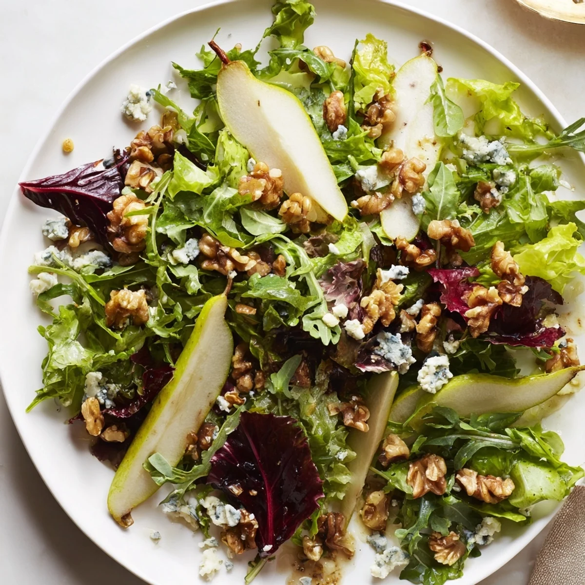 Juicy sliced pears and toasted walnuts mingle with crisp baby kale and peppery arugula in this Winter Green Salad with Pear and Walnuts, drizzled with tangy vinaigrette.