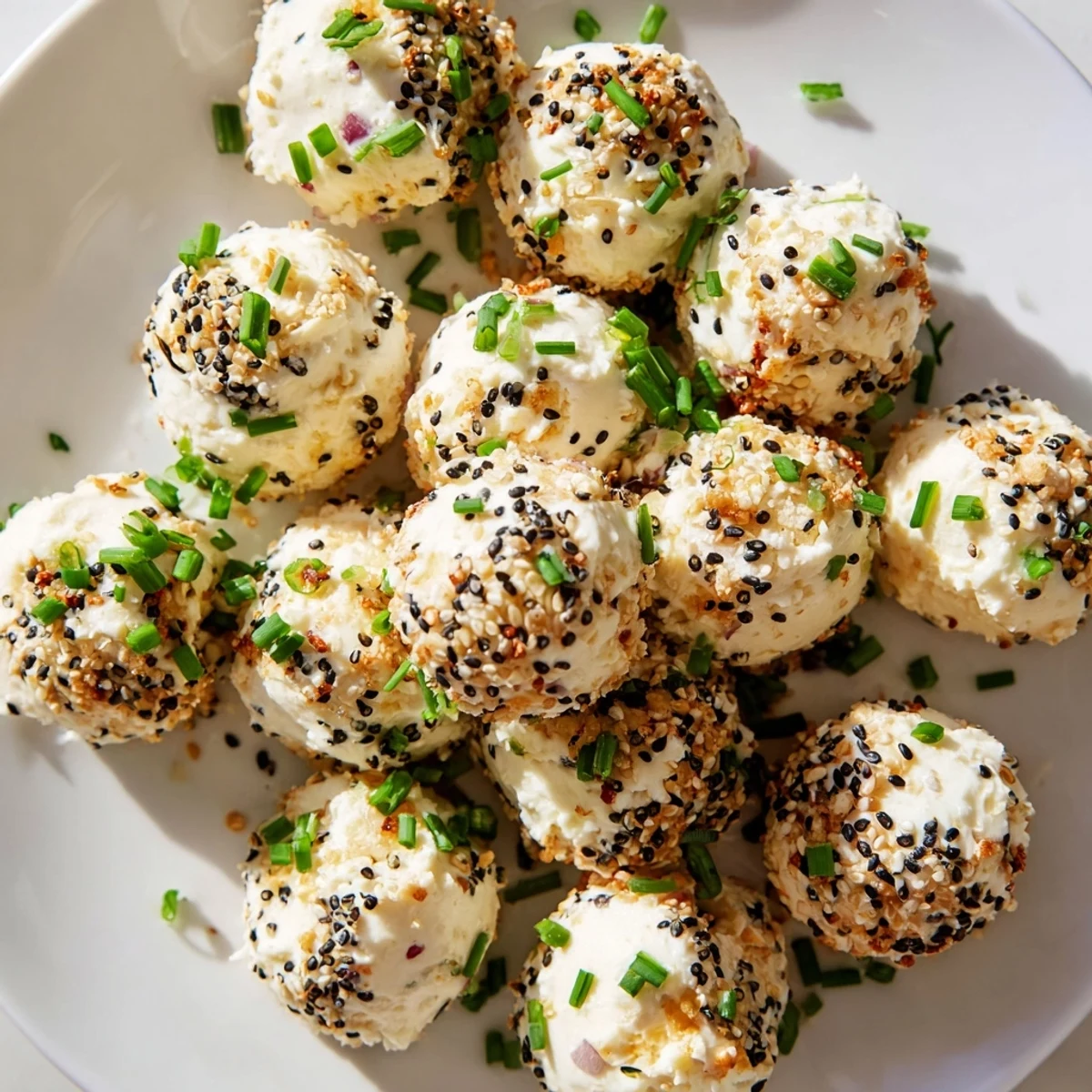 A close-up view shows the creamy texture of the Everything Bagel Cottage Cheese Bites coated in sesame and poppy seeds.