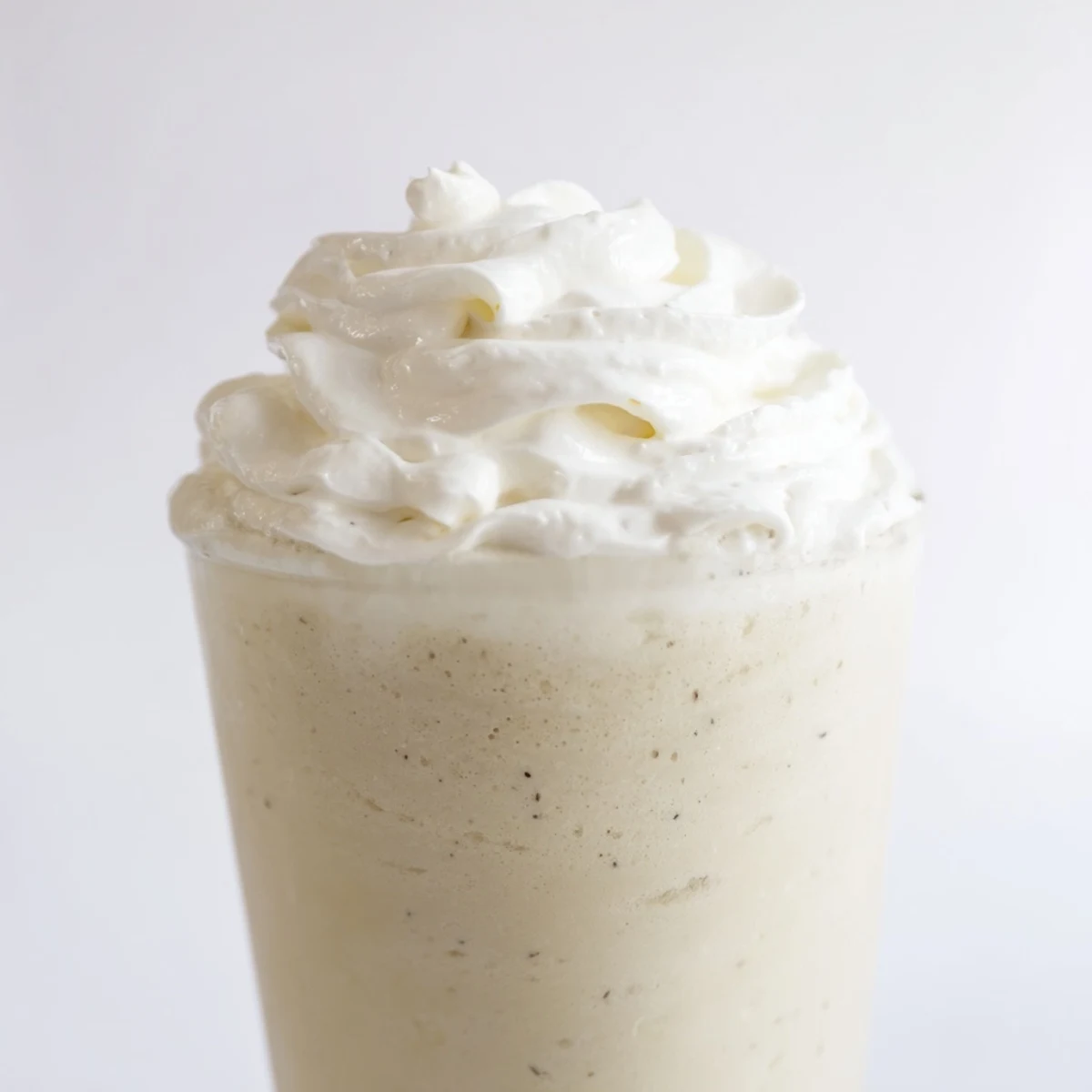 Homemade Starbucks Vanilla Bean Frappuccino blending ice, milk, and vanilla bean ice cream.