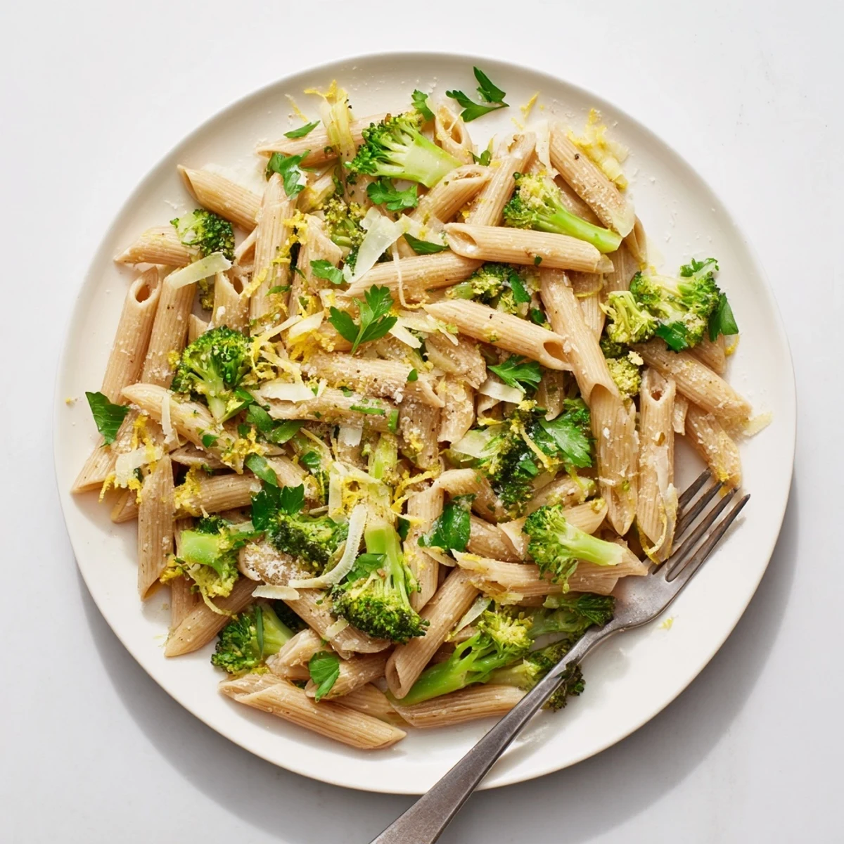 Fresh steamed broccoli florets tossed with whole wheat penne in a light olive oil and garlic sauce, garnished with Parmesan cheese for this Easy Healthy Broccoli Pasta.