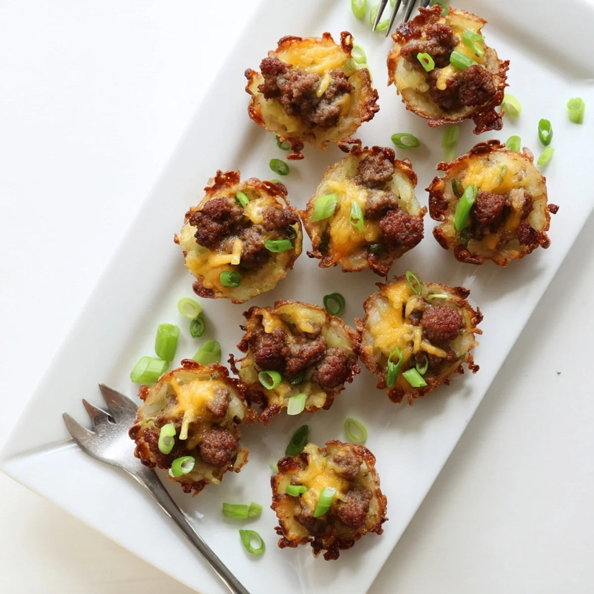 Festive St. Patricks Irish sausage and mashed potato cups garnished with fresh green scallions