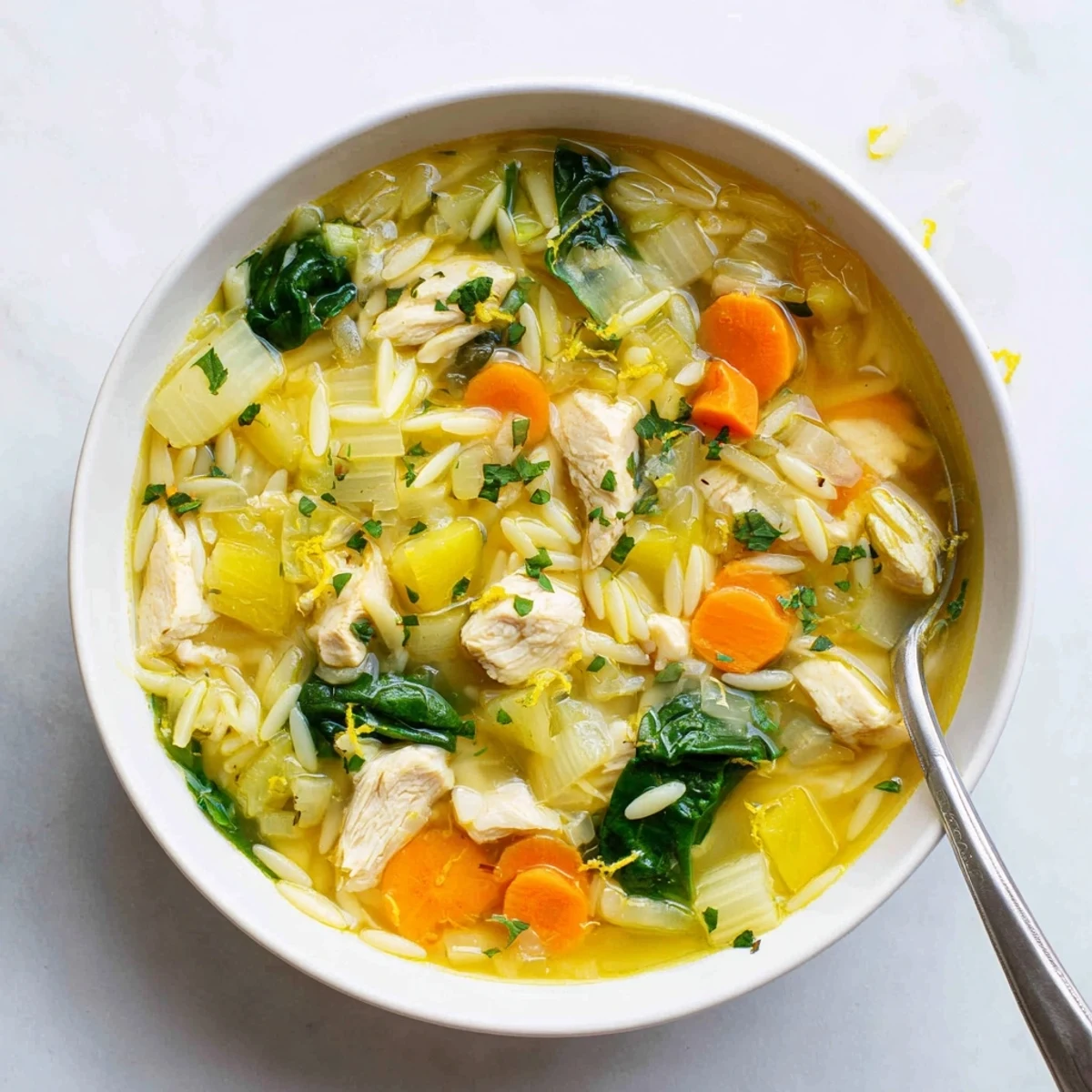 Golden Spring Lemon Chicken Orzo Soup featuring tender chunks, bright vegetables, and al dente pasta in a savory lemon broth