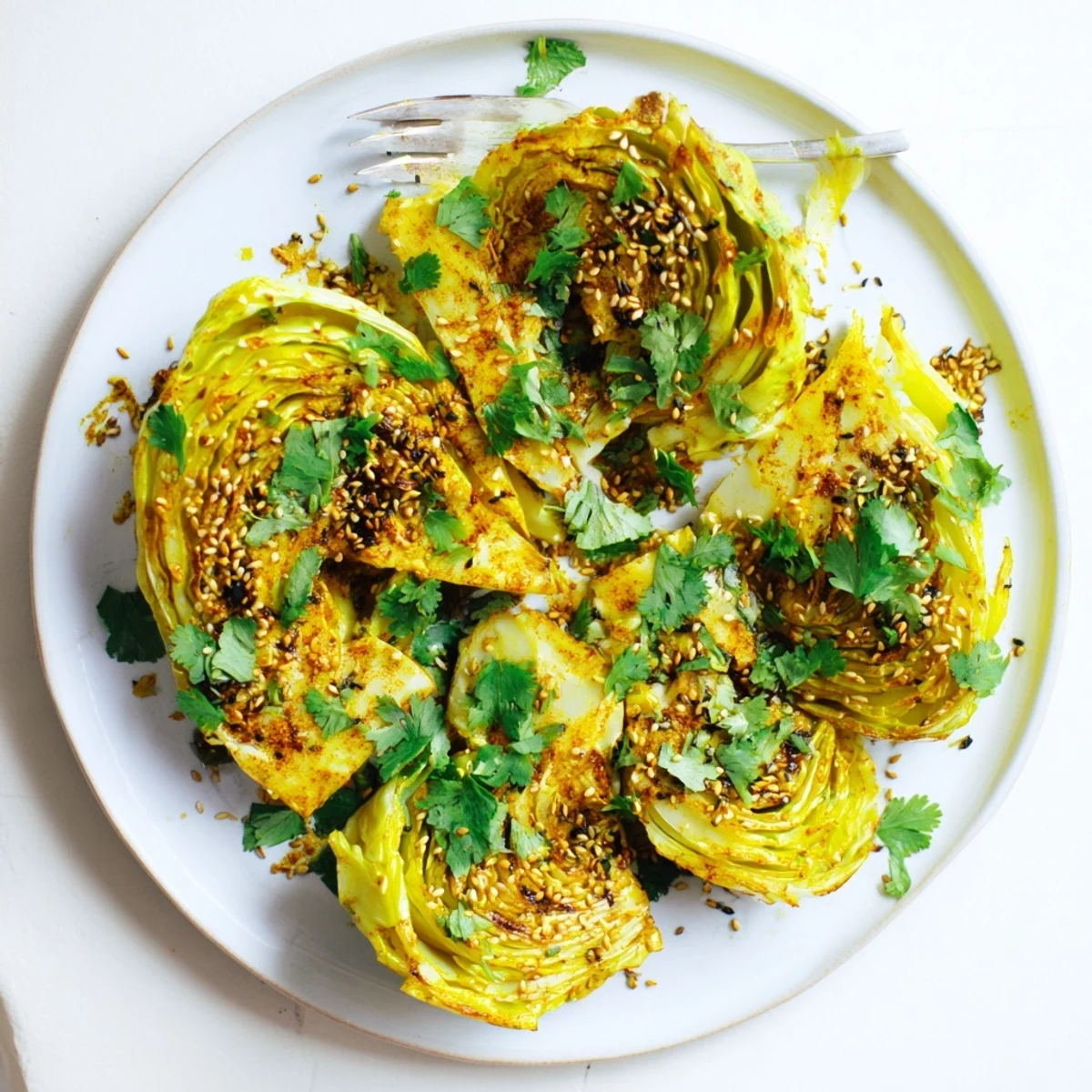 Vibrant tender cabbage roasted with warm curry powder turmeric and cumin seasoning