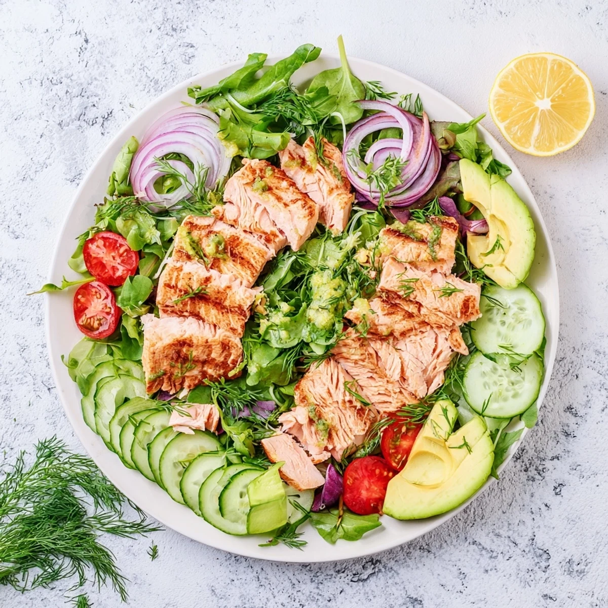 Healthy salmon salad with crisp greens, red onion, and herb garnish ready for quick lunch