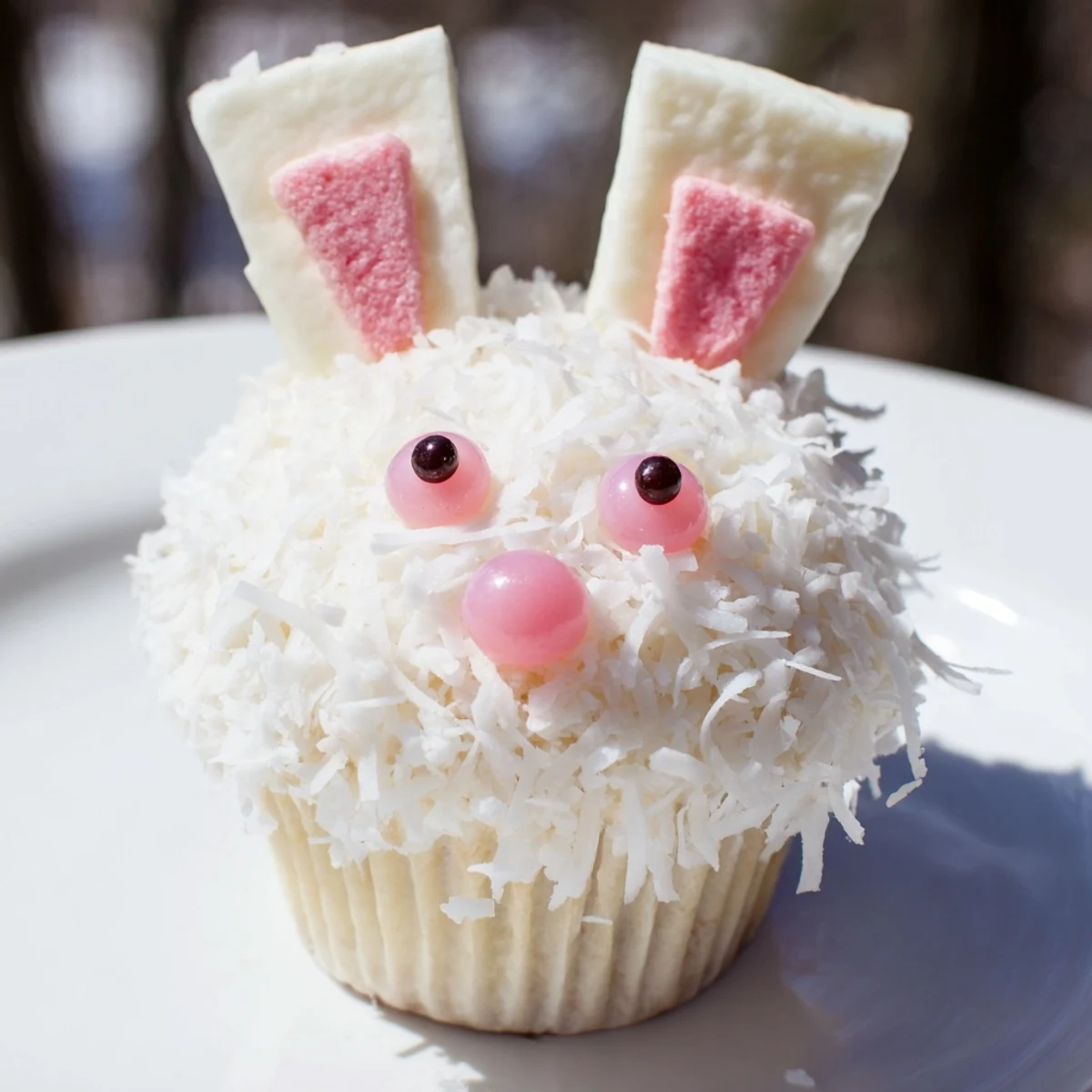 Easter bunny cupcakes featuring buttercream frosting, marshmallow ears, and edible eyes on coconut-dusted tops