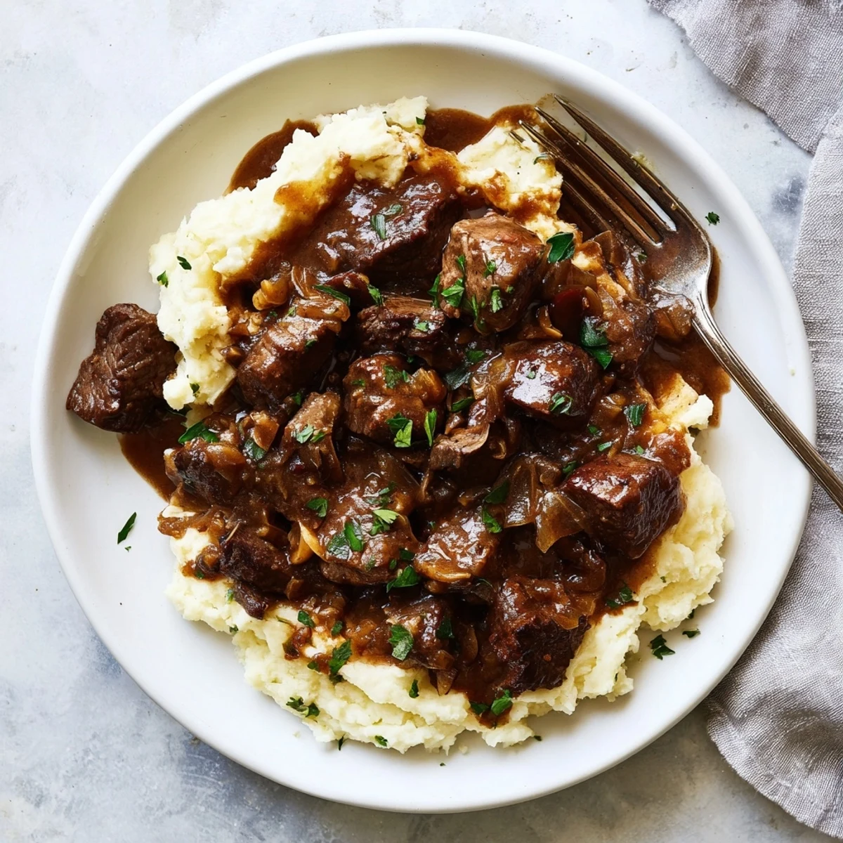 Tender beef cubes simmered in rich brown gravy with fresh parsley garnish