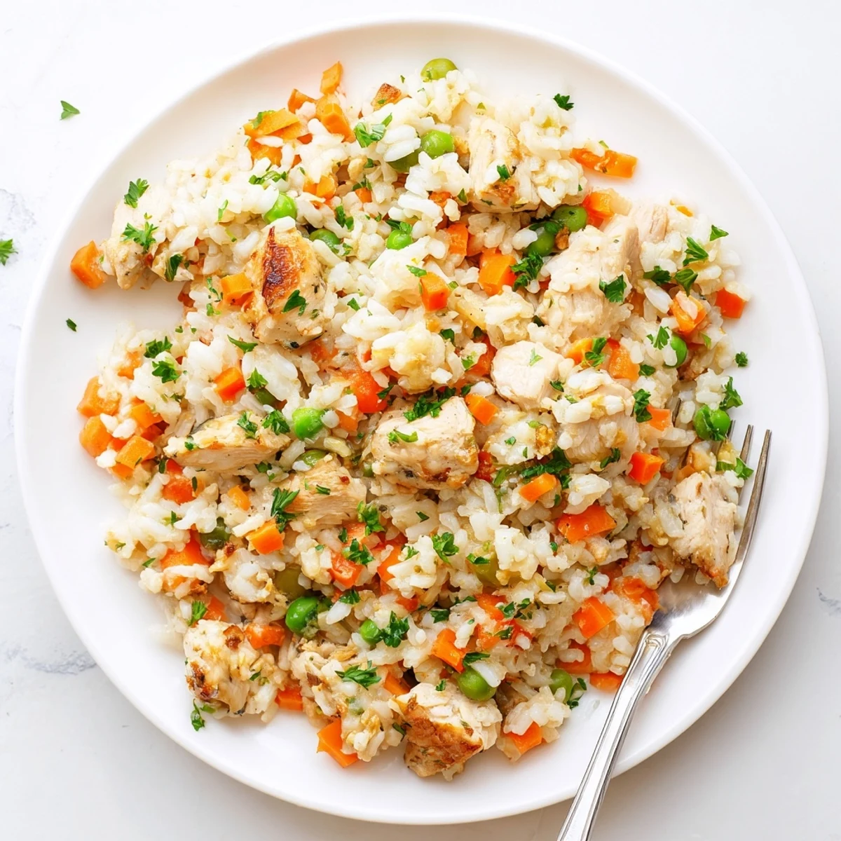 Golden fluffy rice topped with savory chicken and peas from this easy Instant Pot chicken and rice recipe