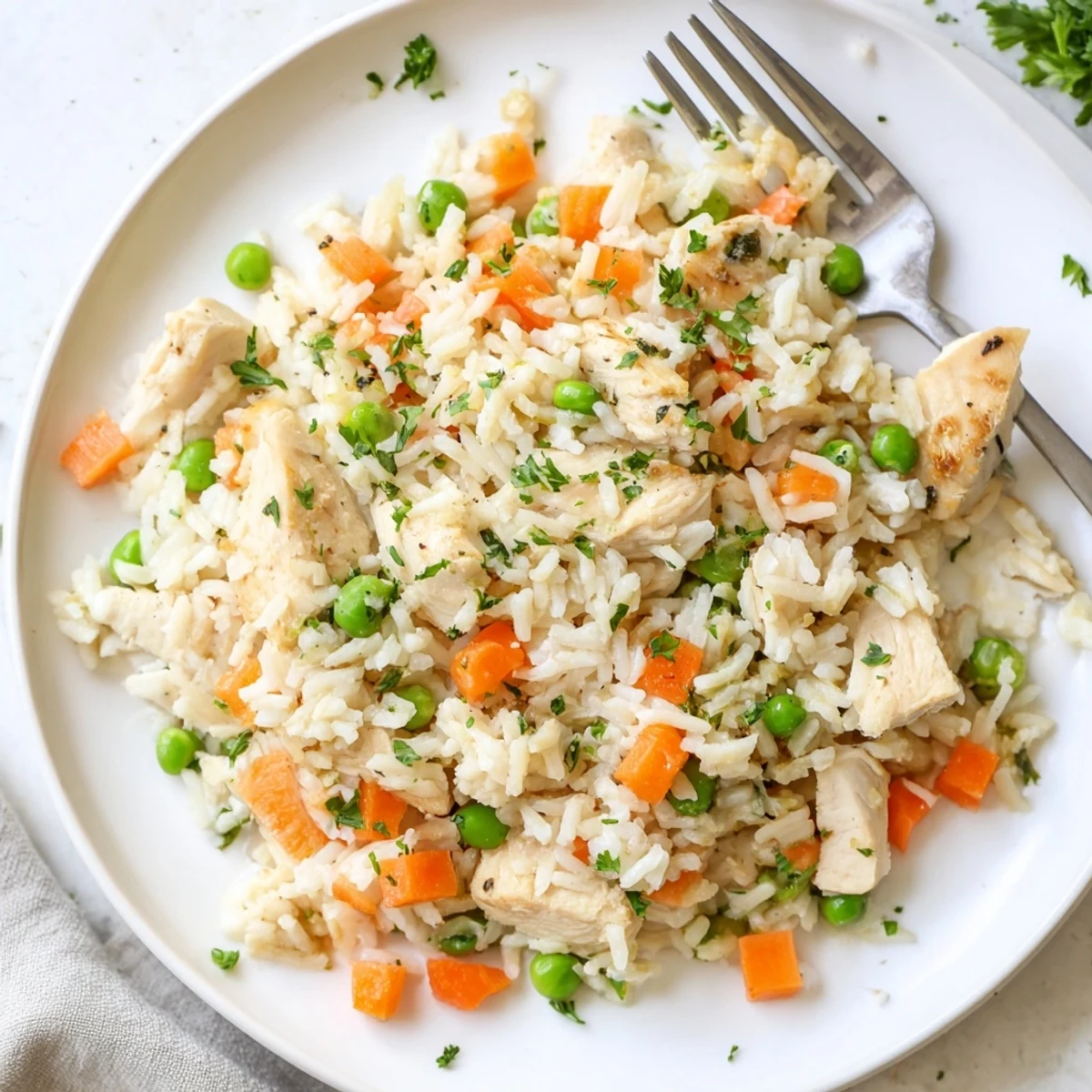 Steaming bowl of Instant Pot chicken and rice recipe garnished with fresh parsley, a comforting weeknight dinner