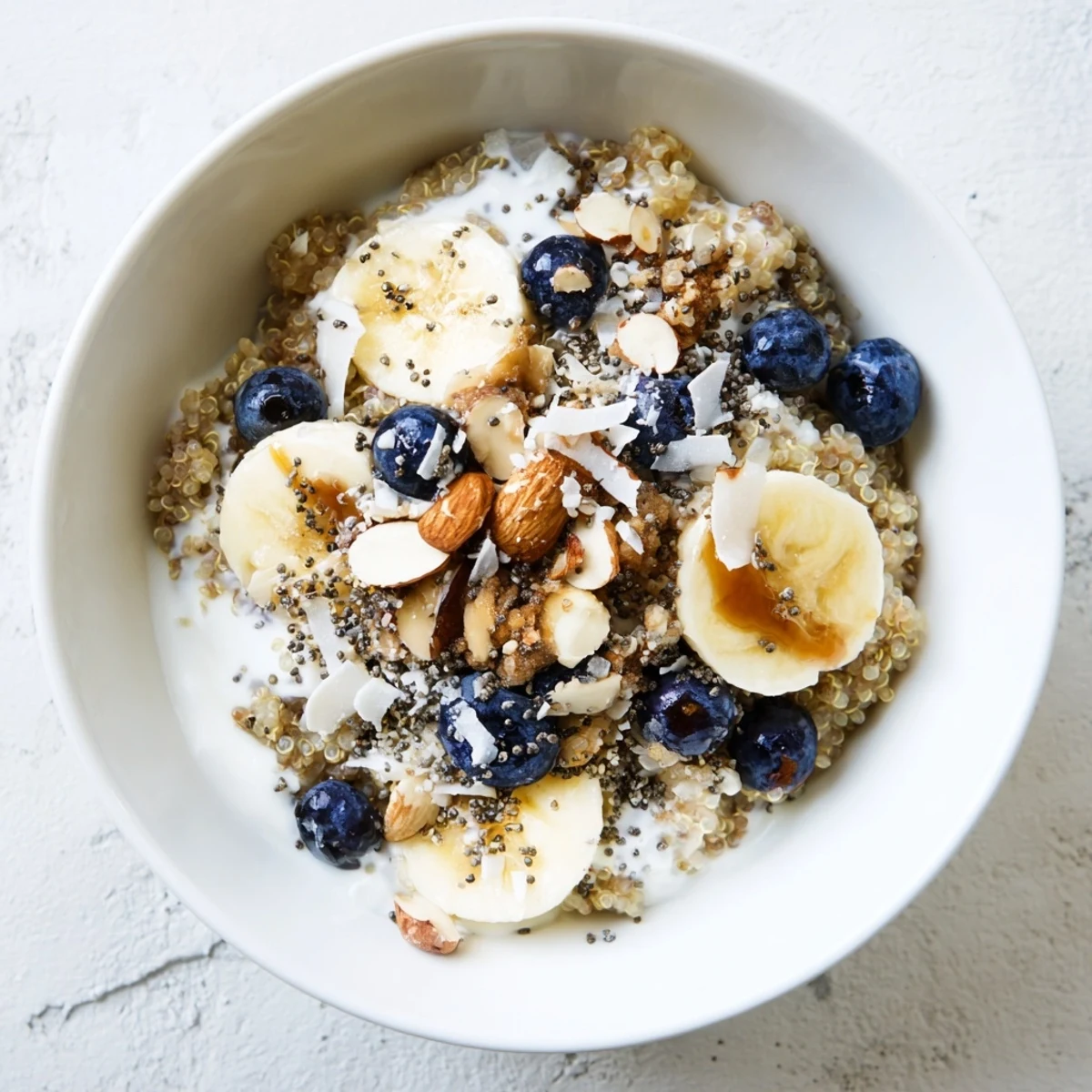 Vibrant morning breakfast bowl featuring fluffy quinoa mixed with fresh blueberries and sliced banana