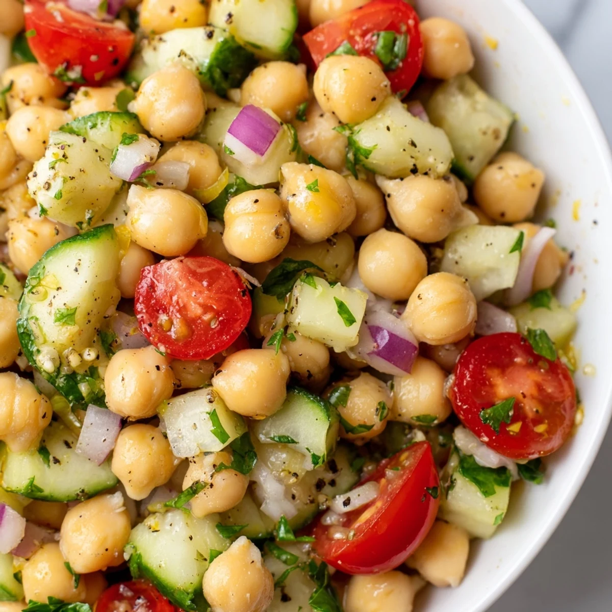 Bright chickpea cucumber salad tossed with cherry tomatoes and herby lemon dressing