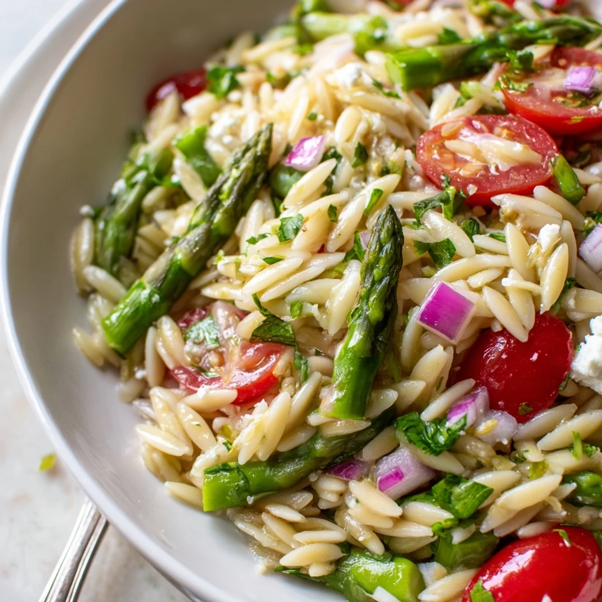Bright Asparagus Orzo Salad With Lemon Vinaigrette invites spring picnics with zesty flavors.