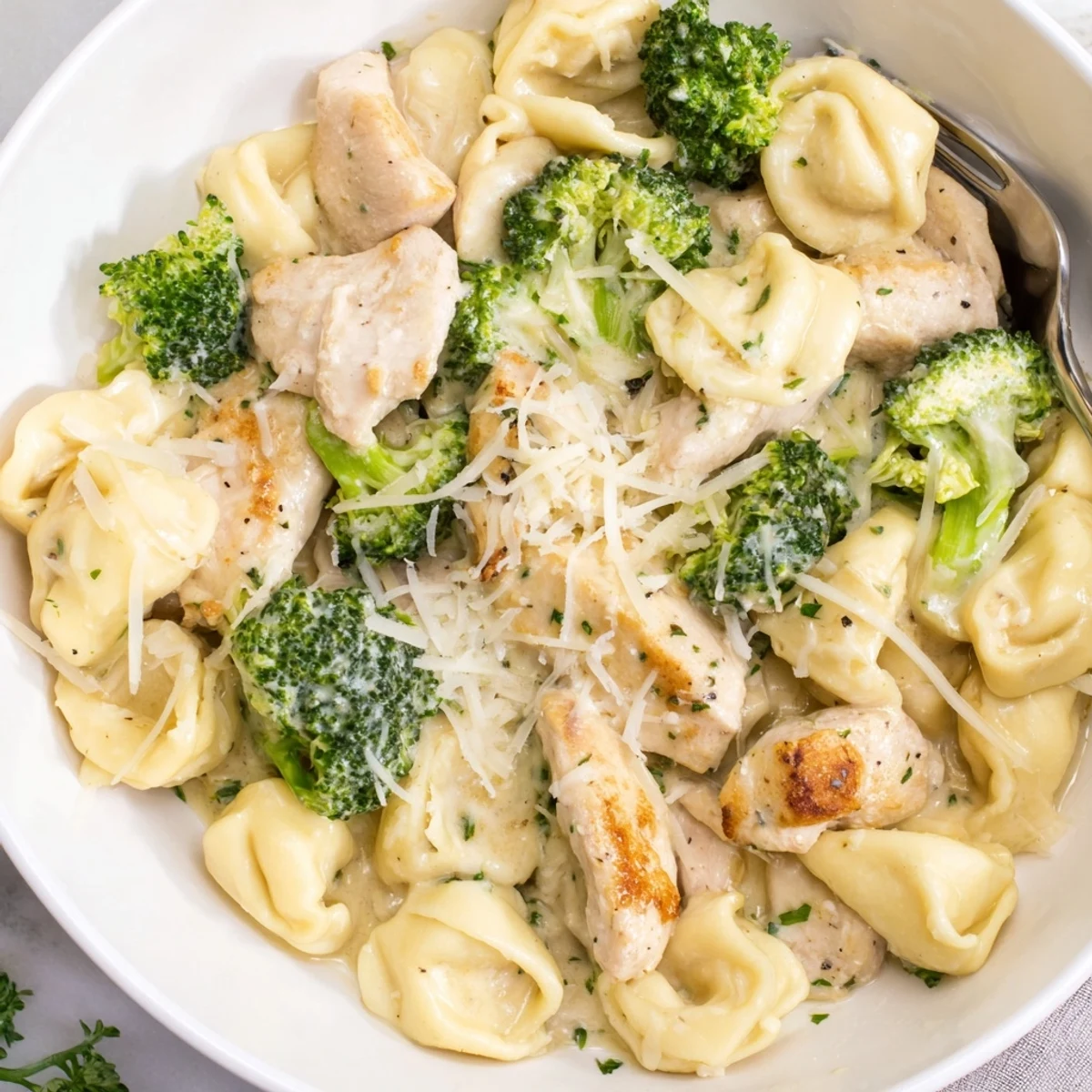 Creamy Garlic Parmesan Tortellini Chicken Broccoli Recipe: steaming tortellini coated in silky garlic-parmesan sauce.