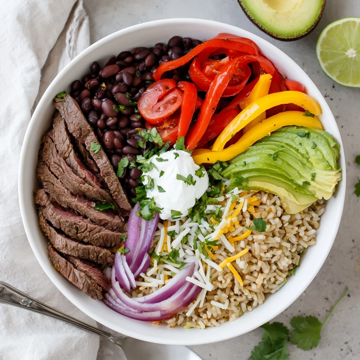 Steak Fajita Power Bowls with sizzling marinated steak, vibrant peppers, creamy avocado.