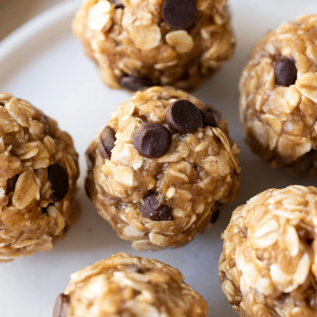 Close-up of soft peanut butter energy balls studded with mini chocolate chips and oats