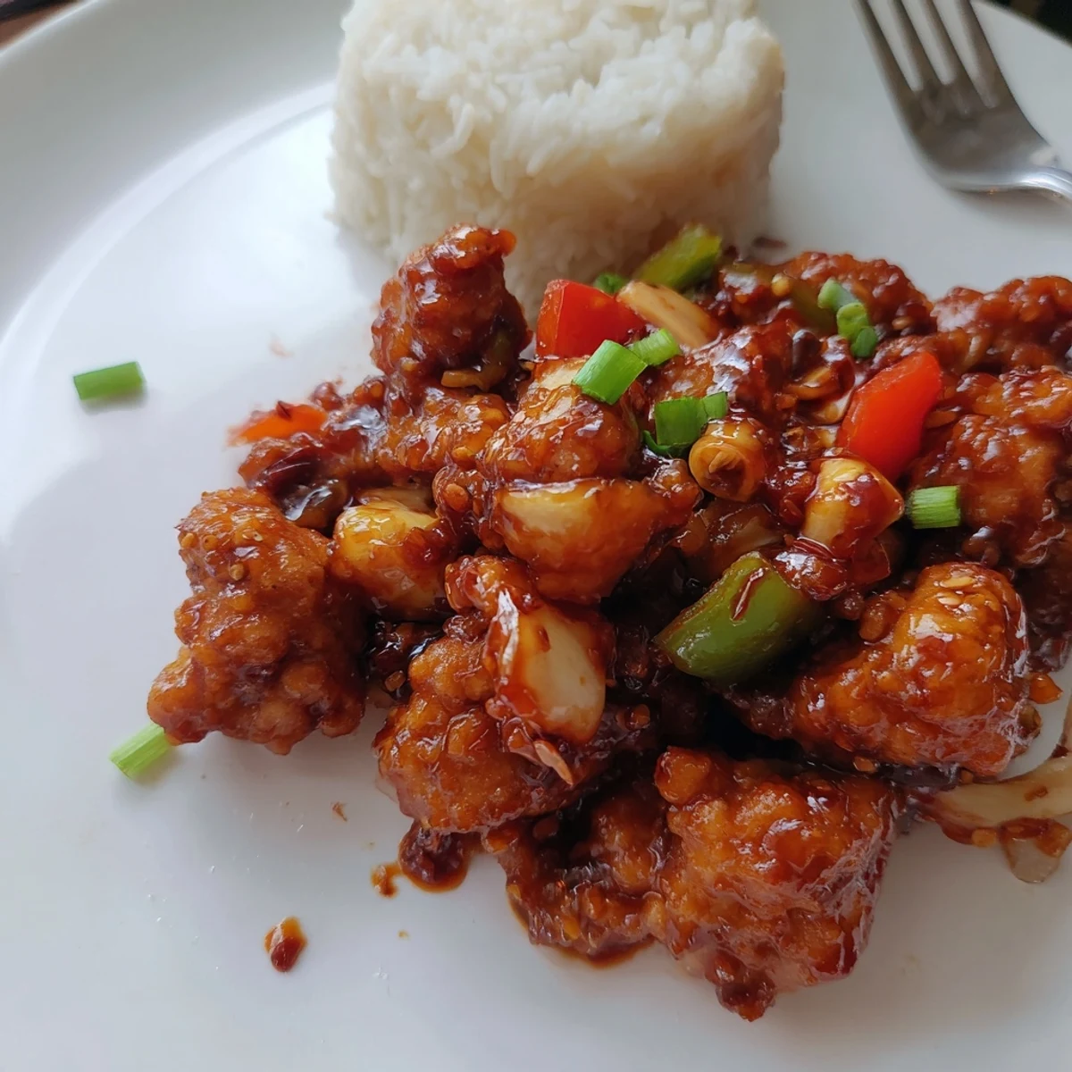 Crispy, saucy Flavorful Chilli Chicken Indo Chinese served steaming over jasmine rice
