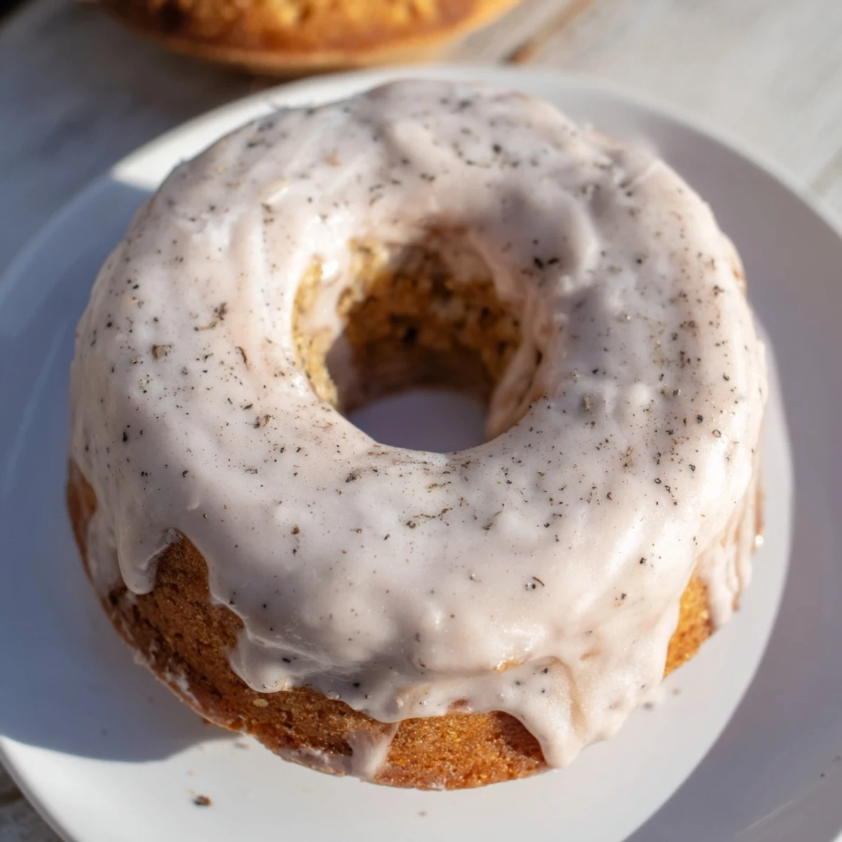 Golden brown banana bread donuts dusted with powdered sugar and cinnamon glaze