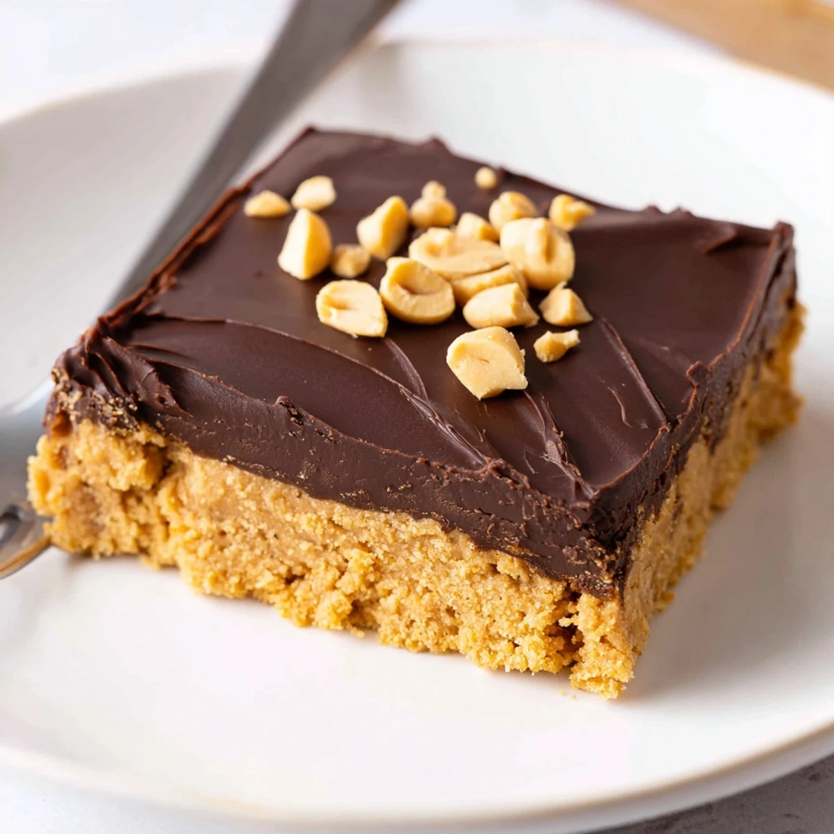Peanut Butter Bars with glossy chocolate topping, dense chewy peanut center, chilled.