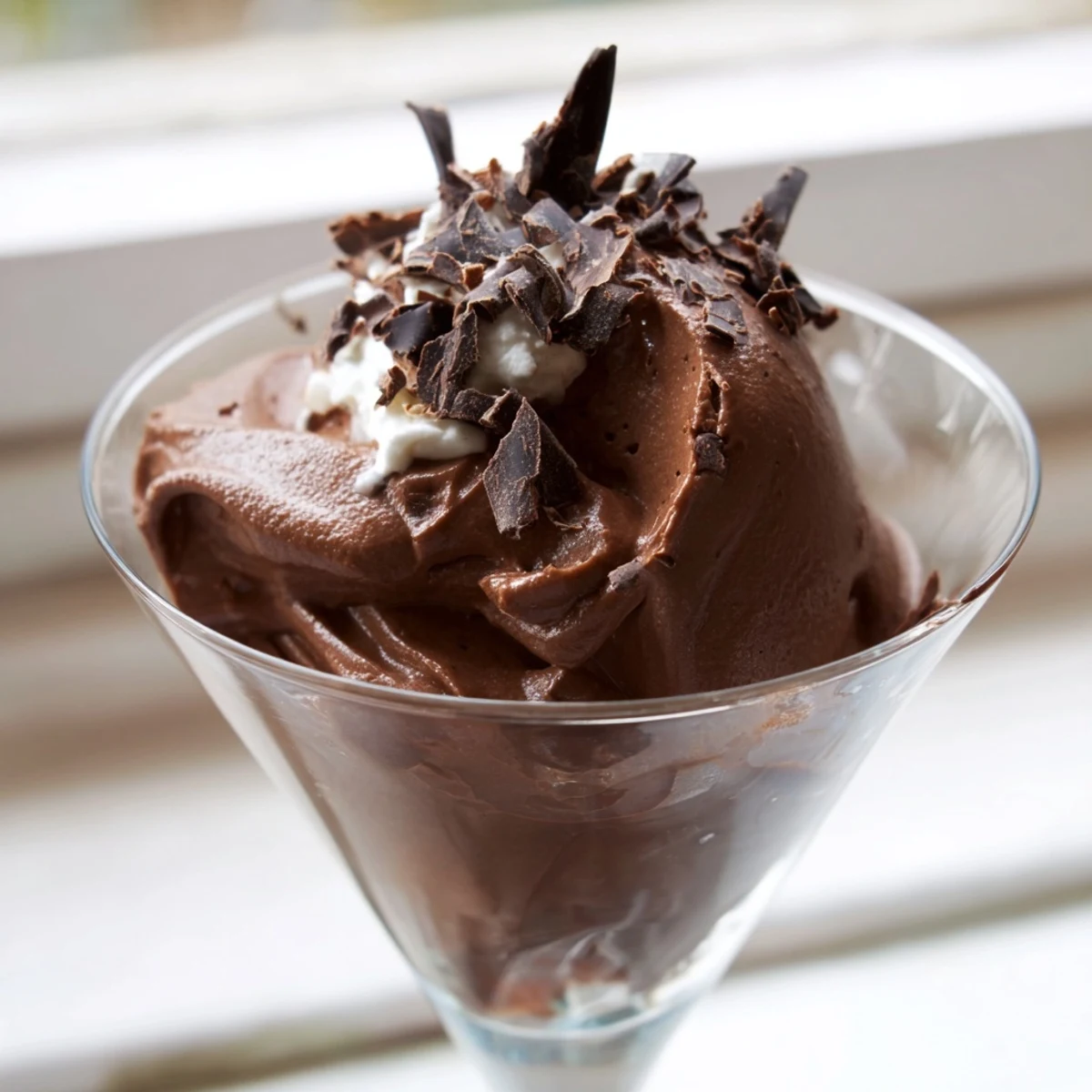Creamy chocolate mousse served in elegant glasses topped with chocolate shavings