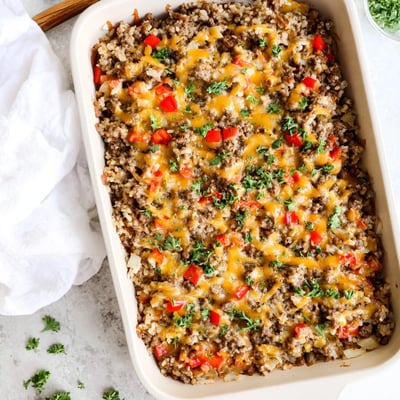 Close-up slice of creamy Ground Beef Casserole with Cauliflower Rice reveals layers of savory beef and tender veggies.
