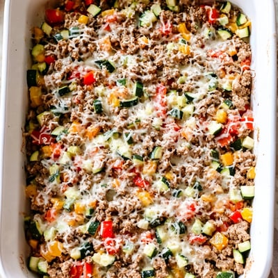 The baked Easy Ground Turkey Zucchini Casserole reveals layers of tender zucchini and ground turkey under a melted cheese topping.