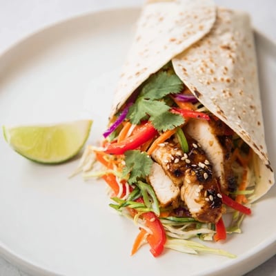 Thai chicken wraps filled with charred chicken strips and vibrant tangy slaw